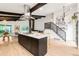 Modern kitchen featuring a center island, stainless steel hood, and a seamless flow to the dining area at 10000 E Ohio Ave, Denver, CO 80247