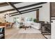 Bright open living room features vaulted ceilings, wood beams, and seamlessly connects indoor and outdoor spaces at 10000 E Ohio Ave, Denver, CO 80247