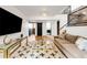 Open-concept living room with stairs to an upper floor and a view of an open kitchen at 10000 E Ohio Ave, Denver, CO 80247