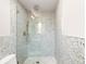 Stylish shower with speckled walls, glass door, rainfall shower head and built-in niche at 10000 E Ohio Ave, Denver, CO 80247