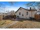 Charming backyard featuring a patio with fire pit, grill, and manicured lawn at 3947 Winona Ct, Denver, CO 80212