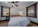 Cozy bedroom with natural light, wood accents, and a modern ceiling fan at 3947 Winona Ct, Denver, CO 80212