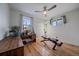 Bright bedroom featuring hardwood floors, a ceiling fan, and a unique plant shelf at 3947 Winona Ct, Denver, CO 80212