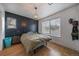 Bedroom with a dark accent wall, hardwood floors, and plenty of natural light at 3947 Winona Ct, Denver, CO 80212