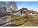 Exterior view of a charming home with a well-maintained lawn and a van in the driveway at 3947 Winona Ct, Denver, CO 80212