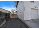 Exterior side view showing the gravel area of the backyard and a two story house at 3947 Winona Ct, Denver, CO 80212