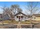 A well-manicured front lawn and mature trees frame this beautiful house exterior at 3947 Winona Ct, Denver, CO 80212