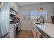 Bright kitchen features stainless steel appliances, quartz countertops, tiled backsplash, and natural light at 3947 Winona Ct, Denver, CO 80212