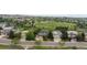 An aerial view shows the roof and surrounding community and greenery, with a baseball field nearby at 9453 Lark Sparrow Dr, Highlands Ranch, CO 80126