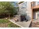 Backyard with hot tub, concrete patio, grass, and tree at 9453 Lark Sparrow Dr, Highlands Ranch, CO 80126