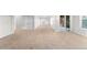 Spacious open basement with beige carpet, white trim, and walk-out door at 9453 Lark Sparrow Dr, Highlands Ranch, CO 80126