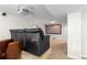 Basement media room with projector and screen, black leather couch on platform and brown leather chairs at 9453 Lark Sparrow Dr, Highlands Ranch, CO 80126