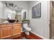 Bathroom boasts granite countertops and a glass vessel sink atop beautiful wood flooring at 9453 Lark Sparrow Dr, Highlands Ranch, CO 80126