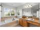 Bright bathroom featuring a tub, granite counters, and a tile backsplash at 9453 Lark Sparrow Dr, Highlands Ranch, CO 80126