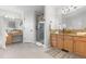 Bathroom featuring double sinks, granite counters, tile floors and a glass door shower at 9453 Lark Sparrow Dr, Highlands Ranch, CO 80126