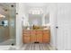 Bathroom featuring a glass bowl sink, granite countertops, and a tiled glass door shower at 9453 Lark Sparrow Dr, Highlands Ranch, CO 80126