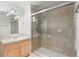 Bathroom with shower, glass door, tile, and light wood cabinets at 9453 Lark Sparrow Dr, Highlands Ranch, CO 80126