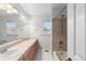 Bathroom with dual sinks, tile floor, and shower-tub combination at 9453 Lark Sparrow Dr, Highlands Ranch, CO 80126