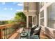 Outdoor deck with wood flooring, black seating, green foliage, and blue sky at 9453 Lark Sparrow Dr, Highlands Ranch, CO 80126