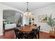 Inviting dining room with an elegant chandelier and views of the staircase at 9453 Lark Sparrow Dr, Highlands Ranch, CO 80126