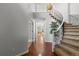 Foyer boasts hardwood floors, curved staircase, and a clear view through to other living spaces at 9453 Lark Sparrow Dr, Highlands Ranch, CO 80126