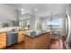 Open kitchen with breakfast bar and plenty of natural light at 9453 Lark Sparrow Dr, Highlands Ranch, CO 80126