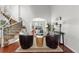 Sunlit living room offering hardwood floors, a view to the dining area, and a cozy, modern design at 9453 Lark Sparrow Dr, Highlands Ranch, CO 80126