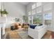 Bright living room features soaring ceilings, a cozy fireplace, and large windows with backyard views at 9453 Lark Sparrow Dr, Highlands Ranch, CO 80126