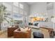 Bright living room boasts large windows and stylish decor, perfect for relaxing or entertaining guests at 9453 Lark Sparrow Dr, Highlands Ranch, CO 80126