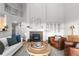 The living room features a cozy fireplace, modern decor, and large windows with natural light at 9453 Lark Sparrow Dr, Highlands Ranch, CO 80126