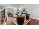 Bright living room featuring hardwood floors, modern decor, and an arched entrance to the dining area at 9453 Lark Sparrow Dr, Highlands Ranch, CO 80126