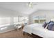 This bedroom features vaulted ceilings, plush carpet and a cozy sitting area at 9453 Lark Sparrow Dr, Highlands Ranch, CO 80126