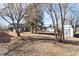 Large backyard with mature trees and storage shed at 6025 S Sycamore St, Littleton, CO 80120