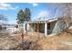 View of a single-story home with a covered porch and some landscaping needing improvements in the front yard at 6025 S Sycamore St, Littleton, CO 80120