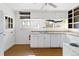 Bright kitchen featuring white cabinets, ample counter space, and a dishwasher, ready for culinary adventures at 6025 S Sycamore St, Littleton, CO 80120