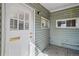 Covered porch featuring a white front door with windows at 6025 S Sycamore St, Littleton, CO 80120