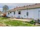 Exterior view of home's backyard with patio, yard, and a rocking chair at 1881 E 95Th Ave, Thornton, CO 80229