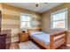 Cozy bedroom featuring wood floors, two windows and a single bed at 1881 E 95Th Ave, Thornton, CO 80229