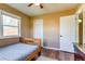 Neutral-toned bedroom featuring wood floors, a window, and an off-white door at 1881 E 95Th Ave, Thornton, CO 80229