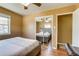 Comfortable bedroom with a ceiling fan and two windows letting in plenty of natural light at 1881 E 95Th Ave, Thornton, CO 80229