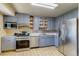 Updated kitchen with stainless steel appliances and gray painted cabinetry at 1881 E 95Th Ave, Thornton, CO 80229