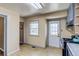 Bright kitchen with an exterior door, laminate flooring, and a window at 1881 E 95Th Ave, Thornton, CO 80229