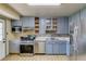 Updated kitchen with stainless steel appliances and gray painted cabinetry at 1881 E 95Th Ave, Thornton, CO 80229