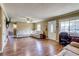 Bright living room with wood floors, white leather sofa and lots of natural light at 1881 E 95Th Ave, Thornton, CO 80229