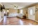 Spacious living room featuring gleaming hardwood floors and a comfortable white leather sofa at 1881 E 95Th Ave, Thornton, CO 80229