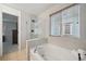 Elegant bathroom showcasing a soaking tub, a glass-enclosed shower, and contemporary fixtures at 2813 Central Park Blvd, Denver, CO 80238