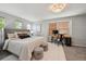 Comfortable bedroom with neutral tones, a well-lit desk area, and plush carpeting for a serene retreat at 2813 Central Park Blvd, Denver, CO 80238
