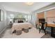 Serene bedroom with ample natural light, complemented by a functional desk area and soft carpeting at 2813 Central Park Blvd, Denver, CO 80238