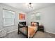 Bright and playful bedroom featuring a unique light fixture and carpet with plenty of natural light at 2813 Central Park Blvd, Denver, CO 80238