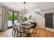 Bright dining area with hardwood floors, modern lighting, and backyard access at 2813 Central Park Blvd, Denver, CO 80238
